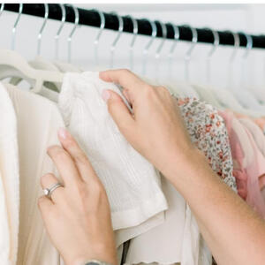 Hand-selecting outfits during an Outfit Curation session in Tucson